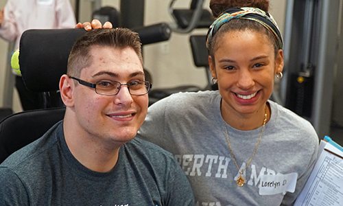 A fitness trainer and a client in a gym at a Get FIT event